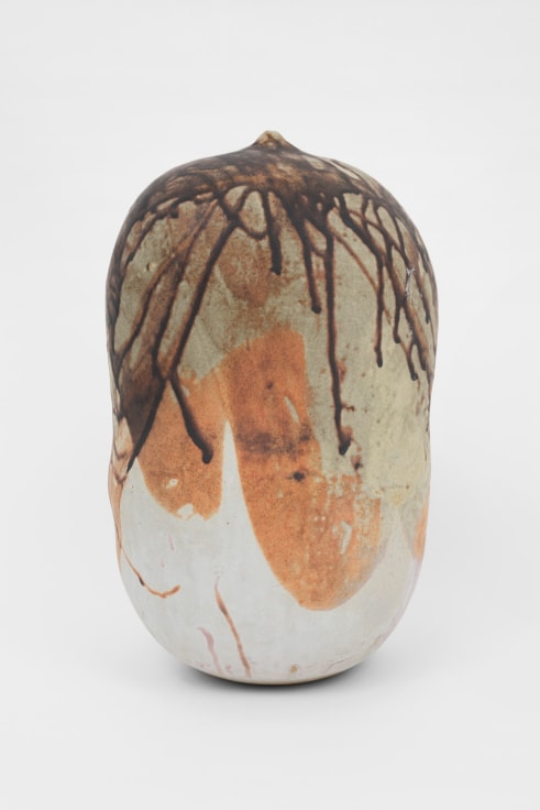 vertical ceramic closed form with shades of white, orange and brown