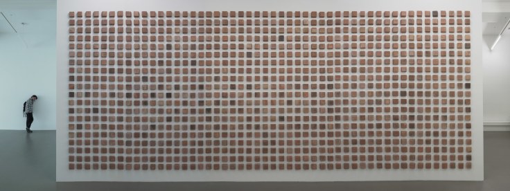 Installation view of 1400 square bricks installed on wall