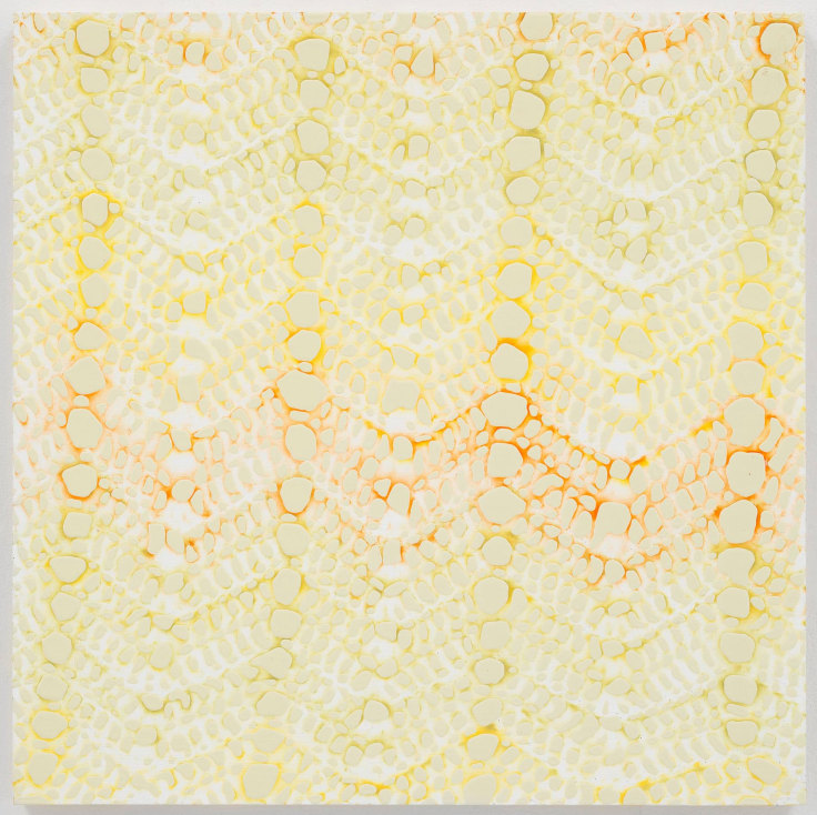 light yellow blots developing a pattern with a yellow and orange tint in the background