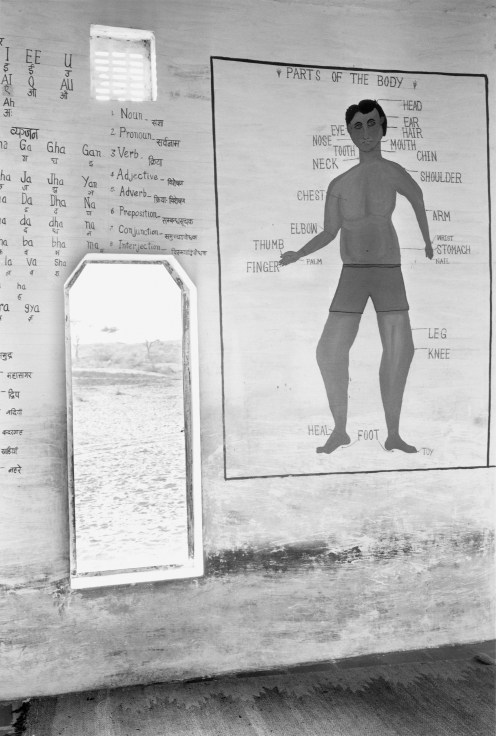 Silver gelatin print featuring wall diagram of labeled human anatomy
