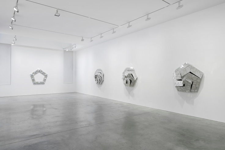view of four glass artworks within a gallery
