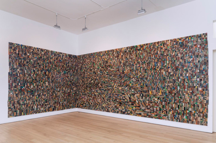 electrical components and wires spanning an artwork that takes up two adjacent walls