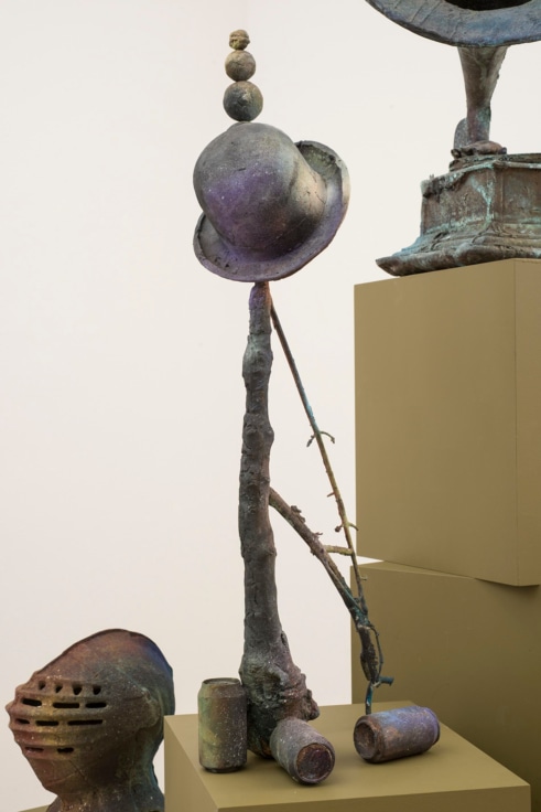 branch hat, and balls balancing on top of each other