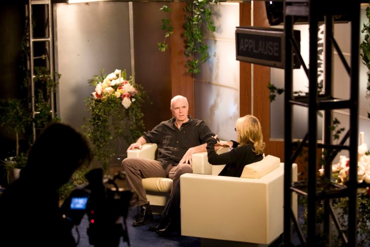 video still of two people on a talk show's set.