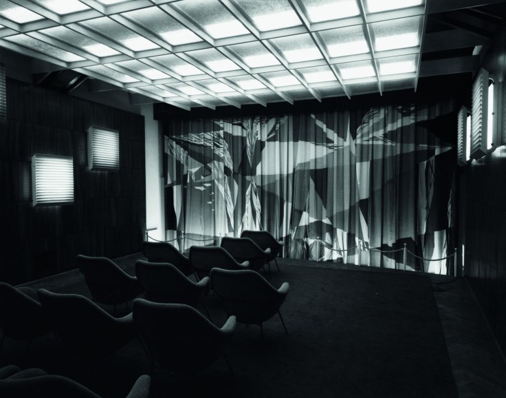 image of a black and white auditorium with a black and white curtain in the front
