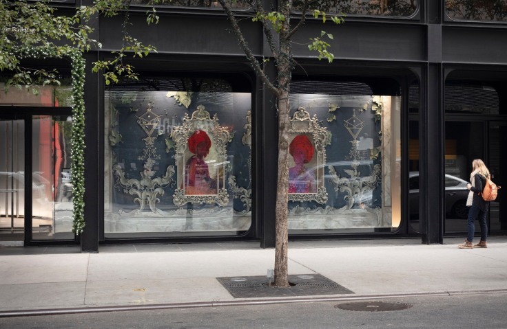 Window-front installation of two portraits of figures wearing turbans outlined by intricate moldings by Firelei B&aacute;ez.