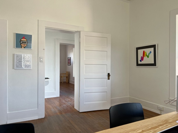 On the upper left is a framed print of a CryptoPunk; on the right is Chromie Squiggle, No. 5618.