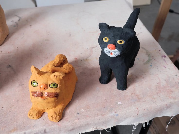 Two sculptures by Sally Saul of cats