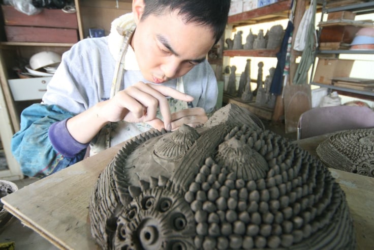 Shinichi Sawada working in the ceramics facility at Nakayoshi Fukushikai in Shiga Prefecture, Japan