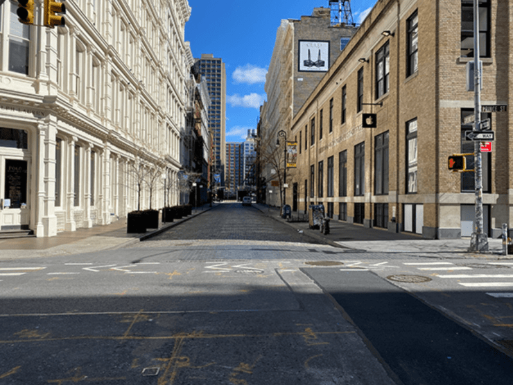 An empty city street is shown in color in this photograph.