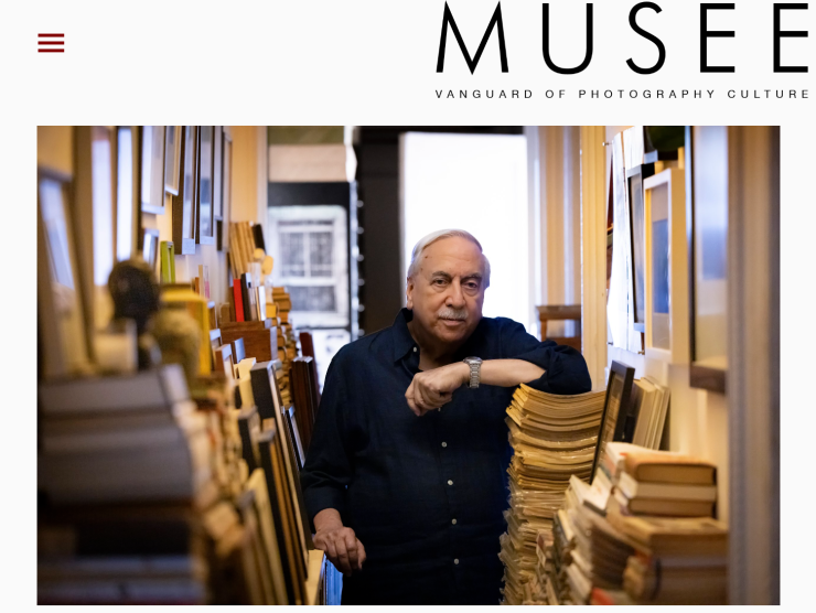 Vince Aletti rests his elbow on a stack of magazines in his home for this Musée featured article.