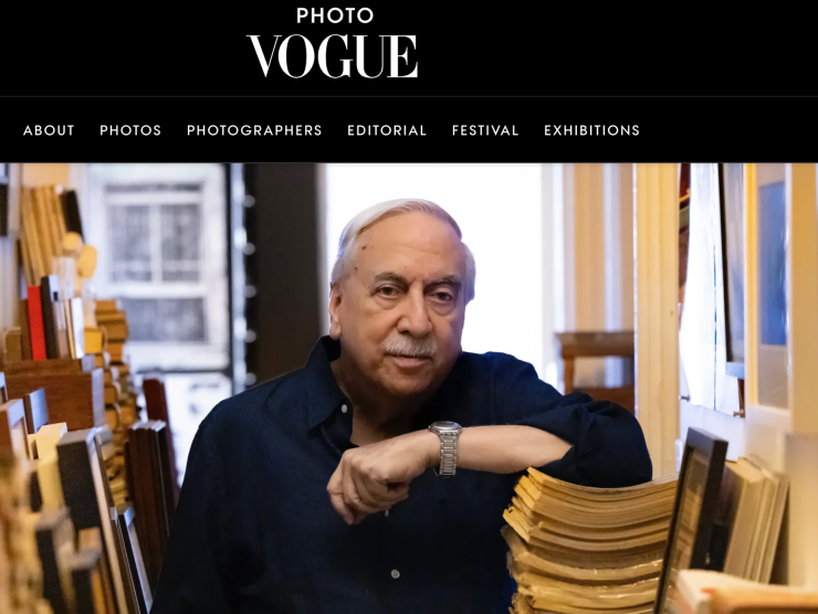 Vince Aletti rests his elbow on a stack of magazines in his home for this Vogue featured article.