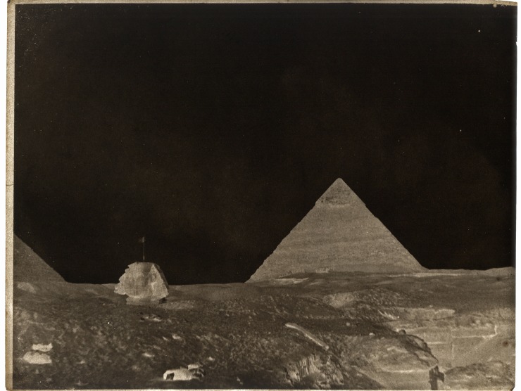 An inverted image of the Egyptian pyramids with a dark sky