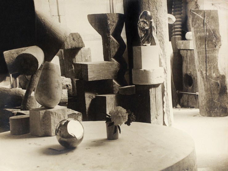 Studio view of several Brancusi sculptures photographed in black and white