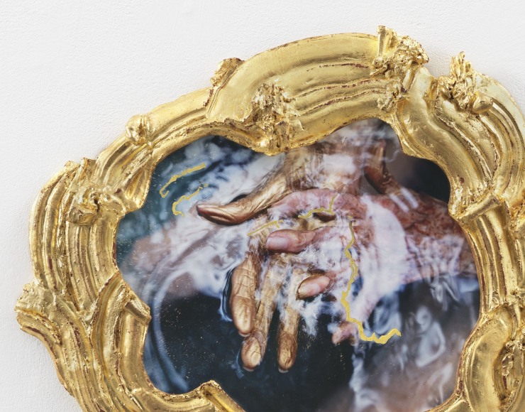 Alt="Janine Antoni, My waters rest, 2019, Mixed media gilded with 24 karat gold leaf, praying hands above blue water"
