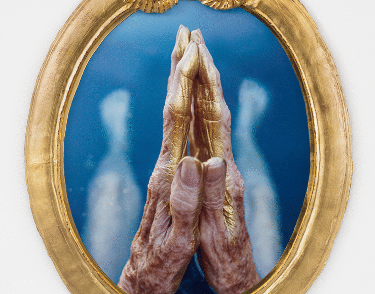 Alt="Janine Antoni, My waters rest, 2019, Mixed media gilded with 24 karat gold leaf, praying hands above blue water"