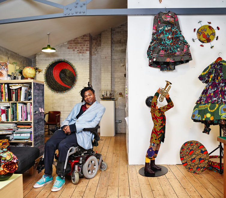 Yinka Shonibare in room full of his works