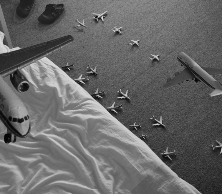tiny airplanes flying and landing around a bedroom