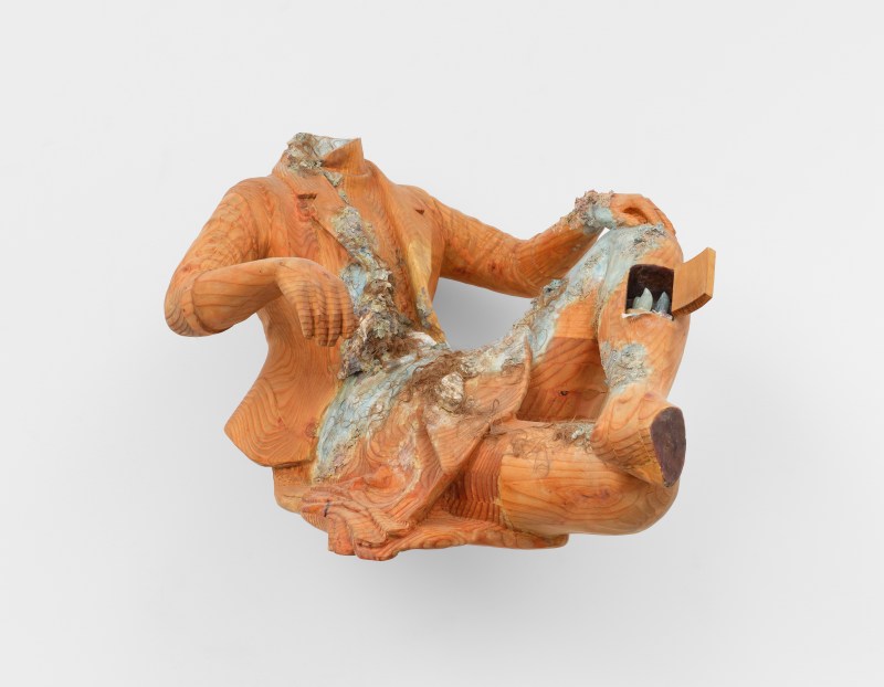 A wooden wall mounted sculpture by Cato Ouyang of a torso