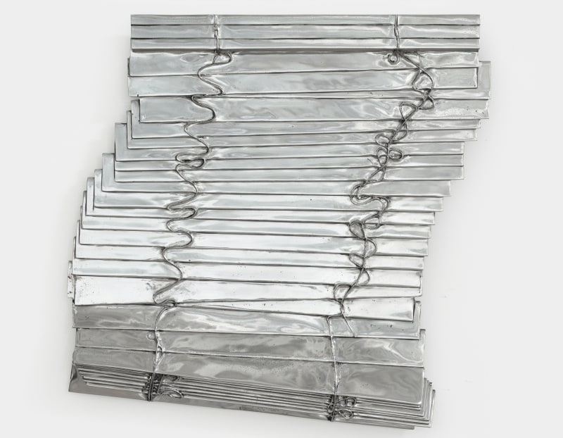 A sculpture by Anne Libby of aluminum cast window blinds.