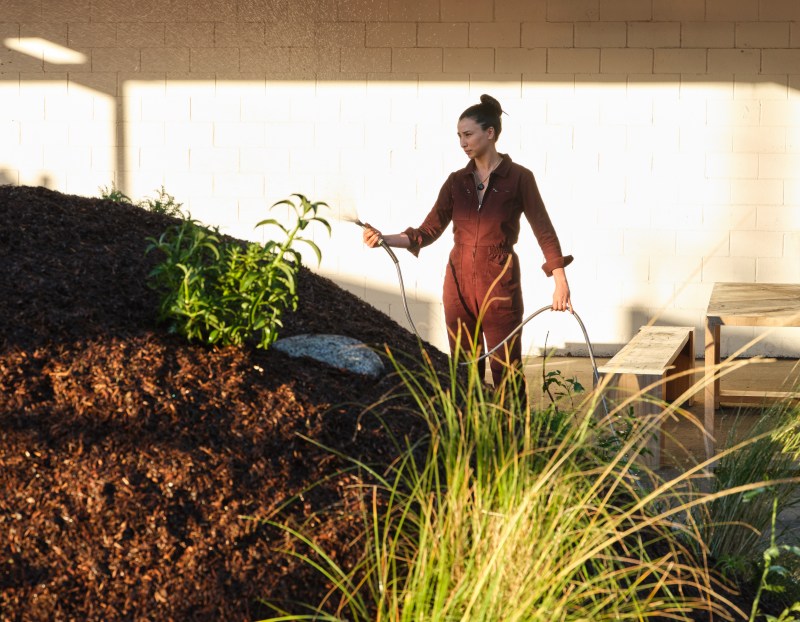 Photo of Lily Kwong watering "Subterrestrial"
