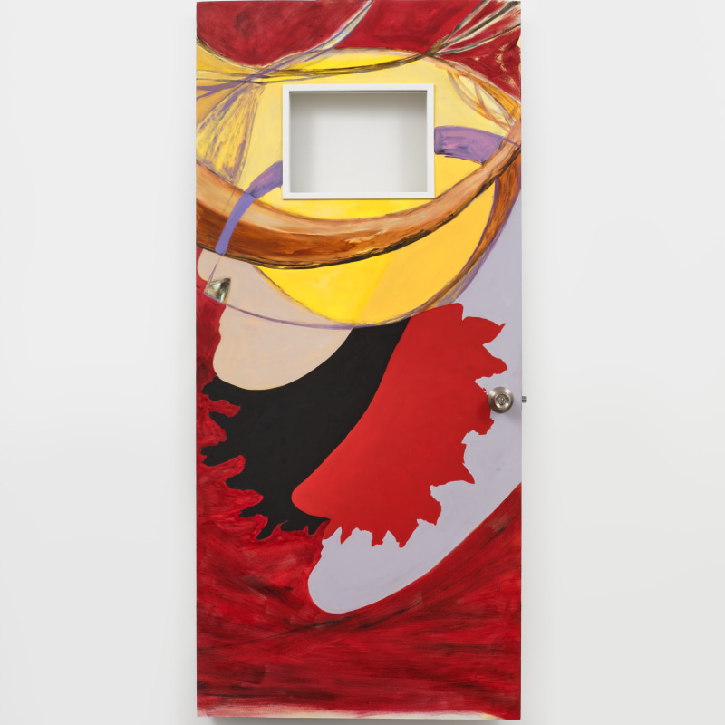A sculptural painting by Marisa Takal on a door with a window, painted in abstract red and yellow patterns.