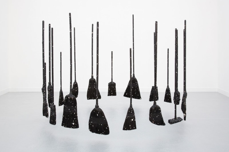 Paul Heyer, &quot;Model of the Universe(s) as Brooms,&quot; 2018, 19 burned brooms with resin, carbon-based paint, and shells, dimensions variable