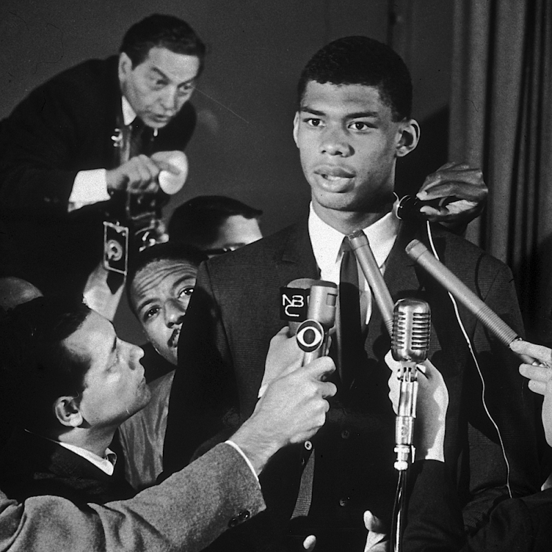 Basketball player Kareem Abdul-Jabbar (center), then Lew Alcindor, speaks at a news conference at the Power Memorial High School gymnasium in New York City.