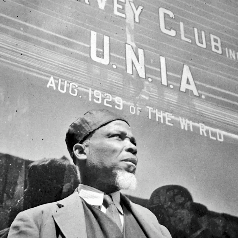 A follower of Marcus Garvey, founder of the Universal Negro Improvement Association,

waits outside a UNIA club in New York in 1943.