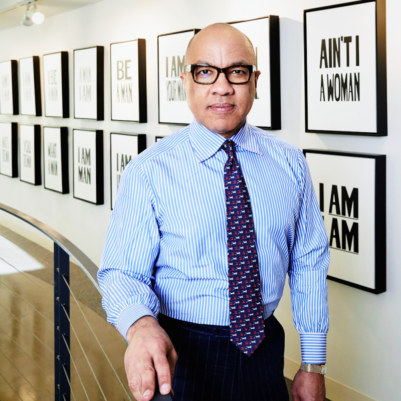 Darren Walker in front of one of his favorite artworks by Hank Willis Thomas,

which hangs just outside his office.