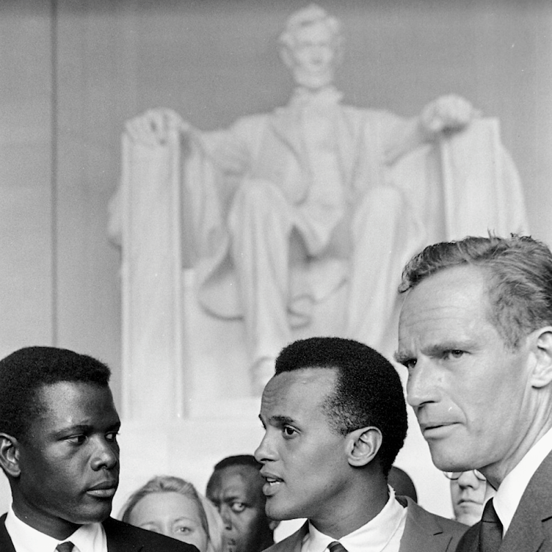 Actor Sidney Poitier, singer Harry Belafonte and actor Charlton Heston participate in the March on Washington on August 28, 1963.