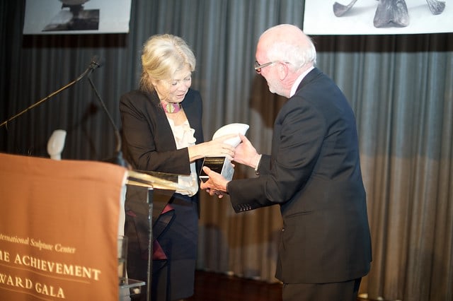 Color photographic of Alice Aycock receiving an award