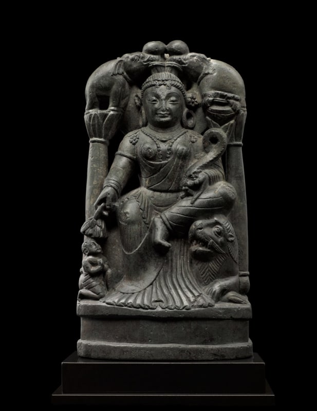 Same photo of Sculpture of Gaja Lakshmi, the Goddess of Fortune, who is venerated as a bringer of good fortune and well-being to the earth, of which she was an early personification.  She wears a long transparent chiton with delicate pleats pooling on the base, beaded jewelry, large hoop earrings, and stylized mural crown. 