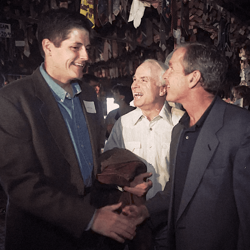 Texas Gov. George W. Bush is greeted by Andy McCain, son of Arizona Sen. John McCain. 1998.