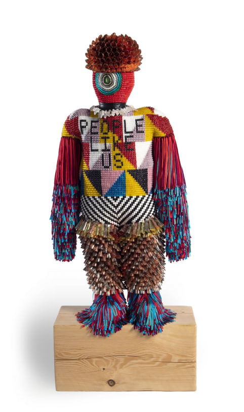 Jeffrey Gibson PEOPLE LIKE US, 2018 Glass and plastic beads, tin, copper and gold-finished jingles, artificial sinew, quartz crystal, silver-coated copper wire, druzy crystal, nylon thread, nylon fringe, acrylic felt, acrylic paint, repurposed wool blanket, recycled jersey stuffing, rawhide, steel rods, wood block 60.5 x 24.5 x 14 in (153.7 x 62.2 x 35.6 cm)