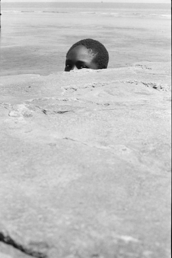 Jimmie Mannas - Peeping Sea Wall Beach Boy, Sea Wall, Georgetown, Guyana, 1972 | Bruce Silverstein Gallery