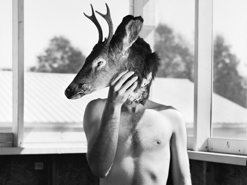 Man and deer head by Timothy Briner