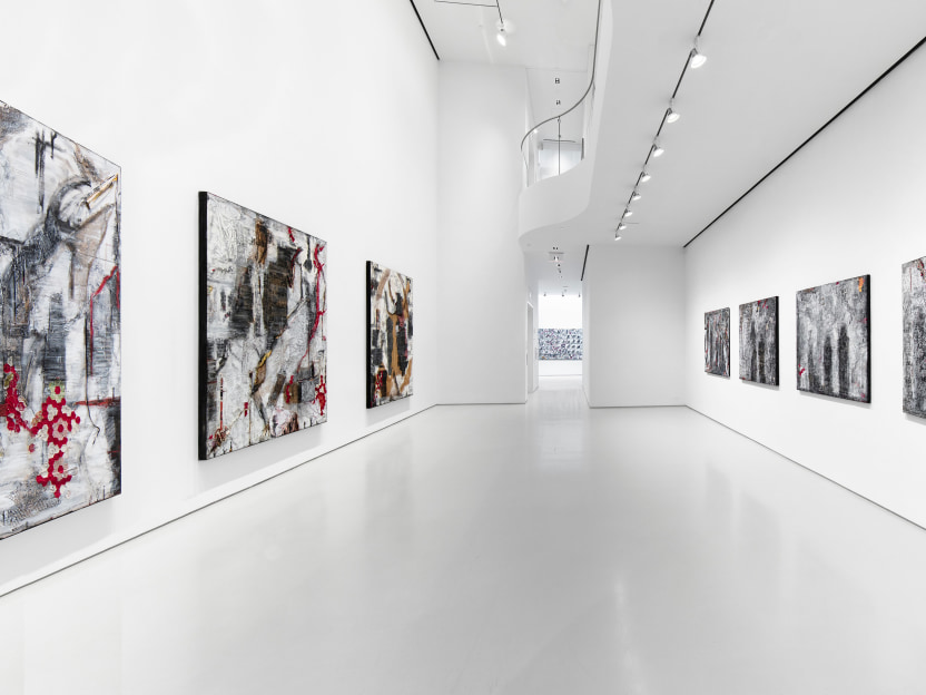 gallery installation view, walls are painted white with three large 8 foot by 6 foot canvases on the left wall, made of burlap and other painted fabrics. on the right are 4 x 4 foot artworks made of lace with shadowy figures painted atop 