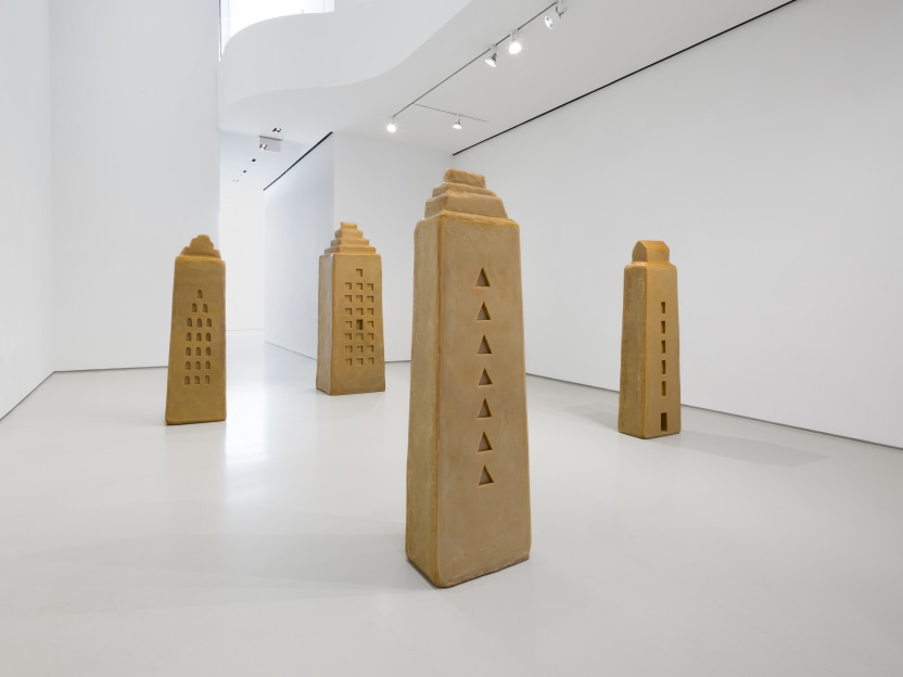 gallery space with four life sized wax sculptures of buildings