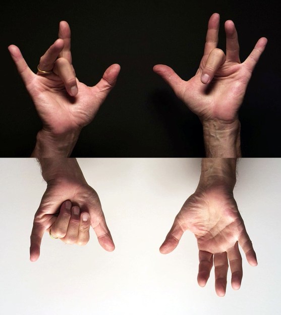 one pair of hands against a black background above another pair of hands against a white background