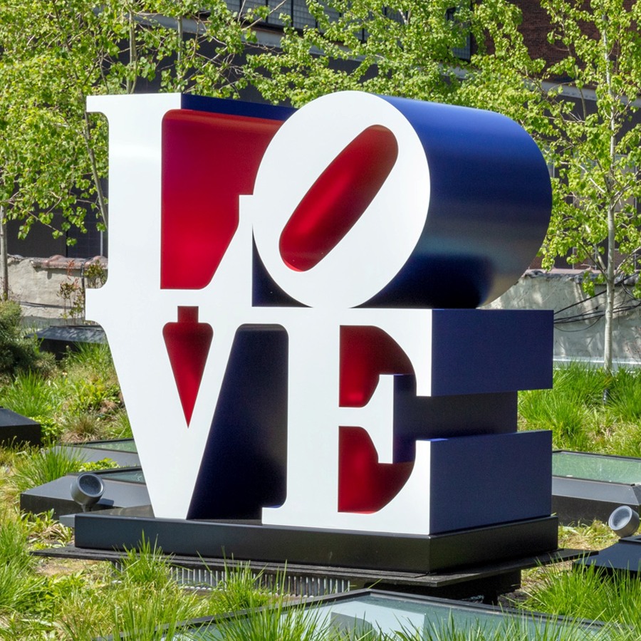 A 72 by 72 by 36 inch polychrome aluminum sculpture spelling love, consisting the letters L and a tilted letter O on top of the letters V and E. The faces of the letters are the color white, the sides are blue, and the insides are red