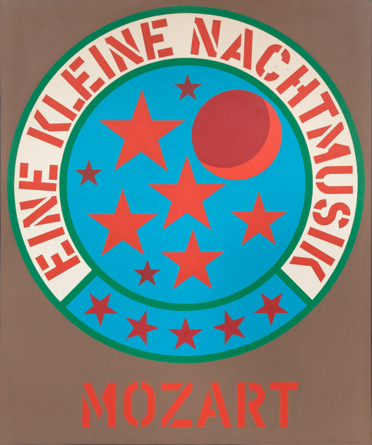 A light brown painting with its title, Mozart, painted in red stenciled letters across the bottom center of the canvas. Above is a blue circle with 8 stars in varying sizes and two shades of red, and a moon in two shades of red. A green outlined ring surrounds the inner circle.  The bottom quarter of the ring is blue and contains five red stars. The rest of the ring is white and contains the text "Eine Kleine Nachtmusik" painted in red stenciled letters.