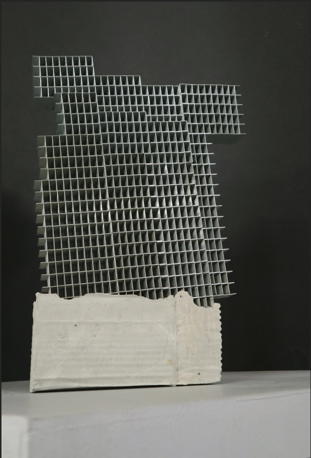 sculpture of a building made out of staple pins and cement