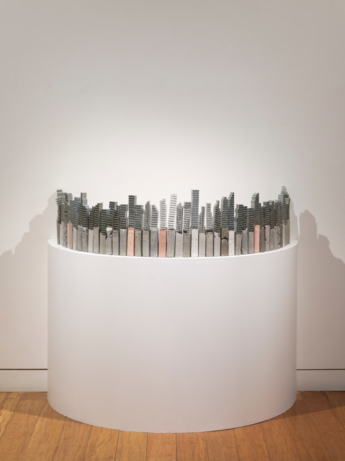 sculpture of buildings made of staple pins and cement