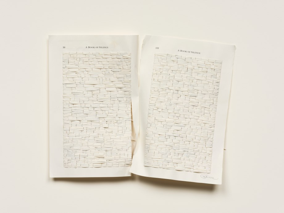 Hand embroidered book strips on reclaimed book pages