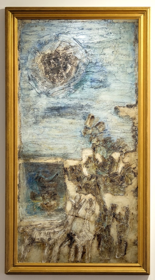 Abstract landscape painting in blue and beige with a large gold frame