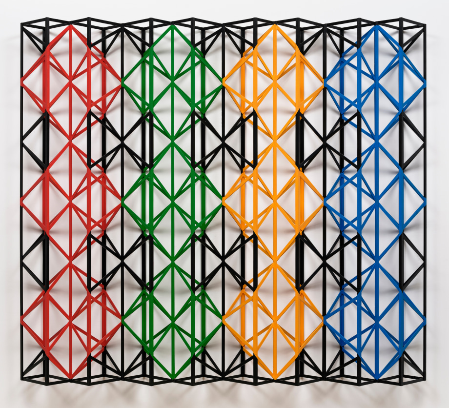 Red, green, yellow, blue geometric wood structure that hangs on the wall