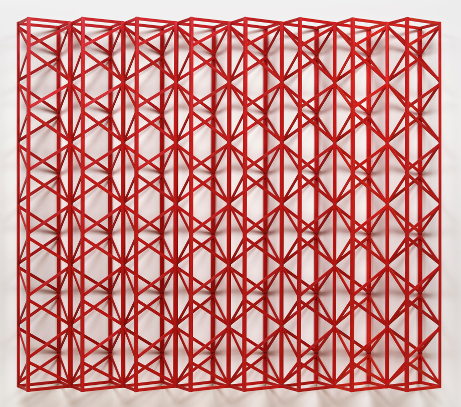 Red wood geometric structure that hangs on the wall
