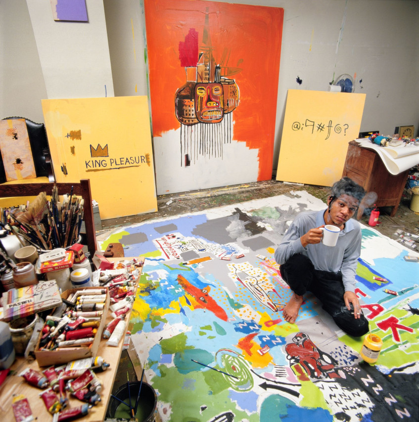 Tseng Kwong Chi, Jean-Michel Basquiat, New York, &ldquo;KING PLEASURE&rdquo; sitting with coffee cup, 1987. Chromogenic print, image: 19 1/2 x 19 1/2 inches, frame: 26 1/2 x 26 1/2 inches.