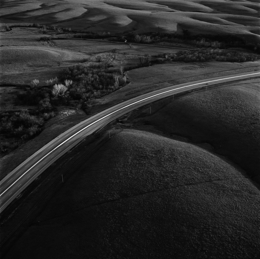 Interstate 35 intersecting the Flint Hills, Kansas,&nbsp;April, 1994.&nbsp;Vintage gelatin silver print, image size 15 x 14 7/8 inches.